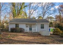 Charming single-story home with light gray exterior, a small front porch, and well-kept yard at 2457 Derby Dr, Raleigh, NC 27610
