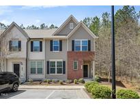 Charming two-story townhouse with brick accents and well-manicured landscaping at 30 Holly Berry Ln, Durham, NC 27703