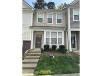 Charming townhome with a well-maintained front yard and inviting entryway at 4423 Sugarbend Way, Raleigh, NC 27606