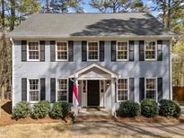 Charming two-story home with black shutters, gray siding, and well-manicured landscaping at 5120 Knaresborough Rd, Raleigh, NC 27612