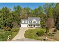Charming two-story traditional home featuring a manicured front yard and a welcoming front porch at 53 Stafford Cir, Clayton, NC 27527