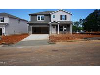 New two-story home featuring a two-car garage, gray siding, and a well-manicured front yard at 700 Deschutes Dr, Garner, NC 27529