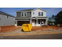 New two-story home with an attached garage and gray siding at 700 Deschutes Dr, Garner, NC 27529