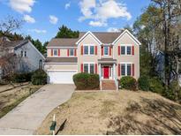 Charming two-story home with red shutters, manicured landscaping, and a two-car garage at 103 Millers Creek Dr, Cary, NC 27519