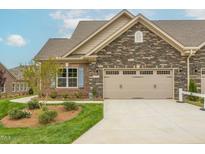 Charming home featuring a stone and brick facade, well-maintained landscaping, and a spacious two-car garage at 1040 Beechcraft Dr # 83, Mebane, NC 27302