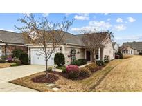 Charming home with a well-manicured lawn, landscaping, and inviting two-car garage at 1404 Palmer Hill Dr, Durham, NC 27703