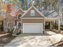 Charming home featuring a large garage, stone accents and a covered carport at 311 Lilliput Ln, Wake Forest, NC 27587