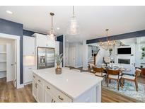 Open concept kitchen features a large island, stainless steel appliances, and views to the dining and living area at 332 Tumbling River Dr, Wendell, NC 27591