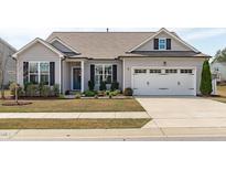 Charming home featuring a two-car garage, well-maintained lawn, and inviting curb appeal at 428 Beaverdam Lake Dr, Fuquay Varina, NC 27526