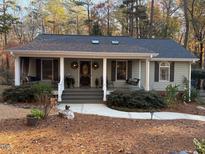 Charming single-story home with a welcoming front porch and well-maintained landscaping at 5313 Pine Dr, Raleigh, NC 27606