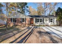 Charming single-story home with brick and vinyl siding, black shutters, and a lovely front door at 5917 Meadowlark Ln, Raleigh, NC 27610