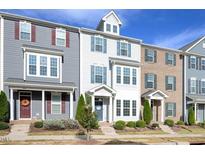 Charming townhome exterior featuring blue shutters and a well-manicured lawn, offering curb appeal at 5918 Giddings St, Raleigh, NC 27616
