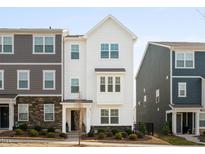 Charming, new construction two-story home featuring a landscaped yard, classic windows, and neutral color palette at 6412 Nurture Ave, Raleigh, NC 27616