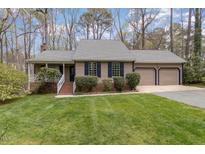 Charming home featuring a well-manicured lawn, a two-car garage, and tasteful landscaping at 7212 Rabbit Run, Wake Forest, NC 27587