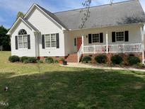 Charming front exterior view with a landscaped yard, porch, and classic architectural details at 126 W Quail Ridge Rd, Oxford, NC 27565