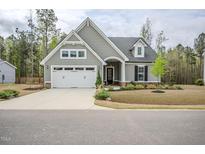 Charming one-story home with a manicured lawn, two-car garage, and a welcoming entrance at 185 W Amber Oak Dr, Selma, NC 27576