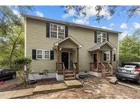 Charming two-story home featuring a quaint front porch and neatly maintained landscaping and dark shutters at 204 Allen St # A/B, Creedmoor, NC 27522