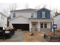 Two-story home featuring white vinyl siding, blue accents, and a spacious two-car garage at 2118 Cherry Creek Rd, Haw River, NC 27258