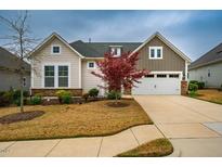 Charming home with a two-car garage, green roof, manicured lawn and a beautiful red Japanese maple tree at 237 Abercorn Cir, Chapel Hill, NC 27516