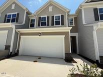 Charming home showcasing a two-car garage with driveway and tasteful exterior design at 237 Shingle Oak Rd, Wake Forest, NC 27587