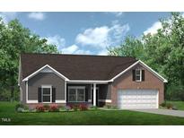 Charming one-story home boasts a brick and siding exterior, a two-car garage, and a well-manicured lawn at 249 Spilona Way # 64, Four Oaks, NC 27524