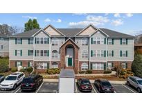 Traditional condominium featuring neutral siding, green shutters, and manicured landscaping at 3471 Forestdale Drive # 3C, Burlington, NC 27215