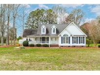 Charming two-story home with a welcoming front porch and well-maintained landscaping at 44 Loop Rd, Archer Lodge, NC 27527