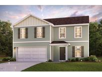 Charming two-story home featuring a welcoming entrance, attached garage, and beautifully landscaped front yard at 5005 Harrier Dr, Snow Camp, NC 27349