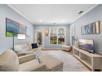 Inviting living room featuring hardwood floors, stylish decor, and abundant natural light at 800 Moratuck Dr # 108, Raleigh, NC 27604