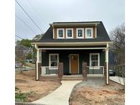 Charming craftsman-style home featuring a covered front porch and inviting curb appeal at 801 N Elm St, Durham, NC 27701