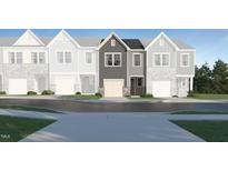 Charming townhome featuring a stone-accented garage and a welcoming front entrance at 804 Windmill Palm Dr, Zebulon, NC 27597