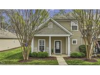 Inviting two-story home featuring a charming front porch with manicured landscaping at 11251 Lofty Heights Pl, Raleigh, NC 27614