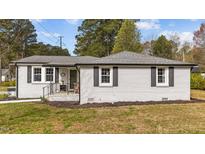 Charming single story home featuring freshly painted exterior, black shutters, and inviting front porch at 116 Lakewood Dr, Wendell, NC 27591
