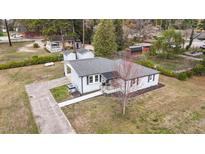 Charming single-story home with a well-manicured lawn and a paved driveway at 116 Lakewood Dr, Wendell, NC 27591
