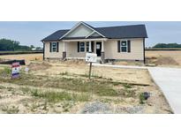 Charming single-story home featuring a covered porch and newly installed siding, walkway, and mailbox at 129 Grace Pond Ave, Benson, NC 27504