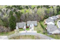 An aerial view of two homes with manicured lawns and lush trees behind the homes at 1808 W Cotton Gin Dr, Clayton, NC 27527