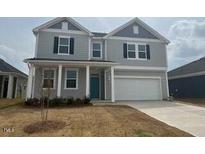 Charming two-story home featuring a welcoming front porch and two-car garage at 190 Chestnut Oak Ln, Lillington, NC 27546