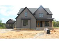 Charming two-story home features a covered porch and complementary detached garage at 20 Serenity Woods Trl, Franklinton, NC 27525