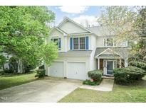 Charming two-story home with a two-car garage, manicured lawn, and mature trees at 206 Newberry Ln, Durham, NC 27703