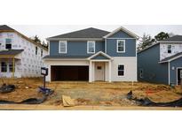 New construction home with blue and white siding and an unfinished front yard at 2207 Cherry Creek Rd, Haw River, NC 27258