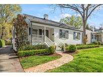 Charming home with a brick walkway leading to a covered front porch and well-manicured landscaping at 2714 Gordon St, Raleigh, NC 27608