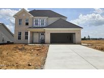 Under construction, this two-story brick home features an attached garage and a long concrete driveway at 2719 Lacy Holt Rd, Graham, NC 27253
