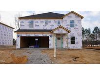 Unfinished two-story home with attached two-car garage, Tyvek HomeWrap, and dark roof shingles at 3857 Rosebush Dr, Zebulon, NC 27597