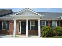 Charming brick home with a covered front entrance, white columns, and black shutters, creating a welcoming curb appeal at 536 Dearing Dr, Haw River, NC 27258