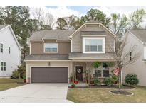 Charming two-story home with a well-manicured front yard and an attached garage at 659 Lavenham Ln, Fuquay Varina, NC 27526