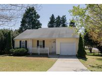 Charming single-story home with a cozy front porch and well-manicured lawn, offering great curb appeal at 702 E Chatham St, Apex, NC 27502