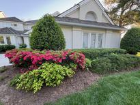 Charming home exterior with vibrant landscaping and manicured bushes, adding curb appeal at 737 Crabtree Crossing Pkwy, Cary, NC 27513