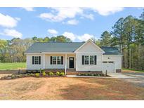 Charming single-story home with classic white siding, black shutters, and a well-manicured front yard at 9550 Stallings Road Rd, Spring Hope, NC 27882