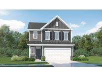 Charming two-story home featuring a modern design and a well-maintained front lawn with lush greenery at 1002 Sora Way, Durham, NC 27703