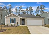 Charming single-story home features a two-car garage and well-maintained front lawn with nice landscaping at 1012 Ringhill Bluff Dr, Durham, NC 27704